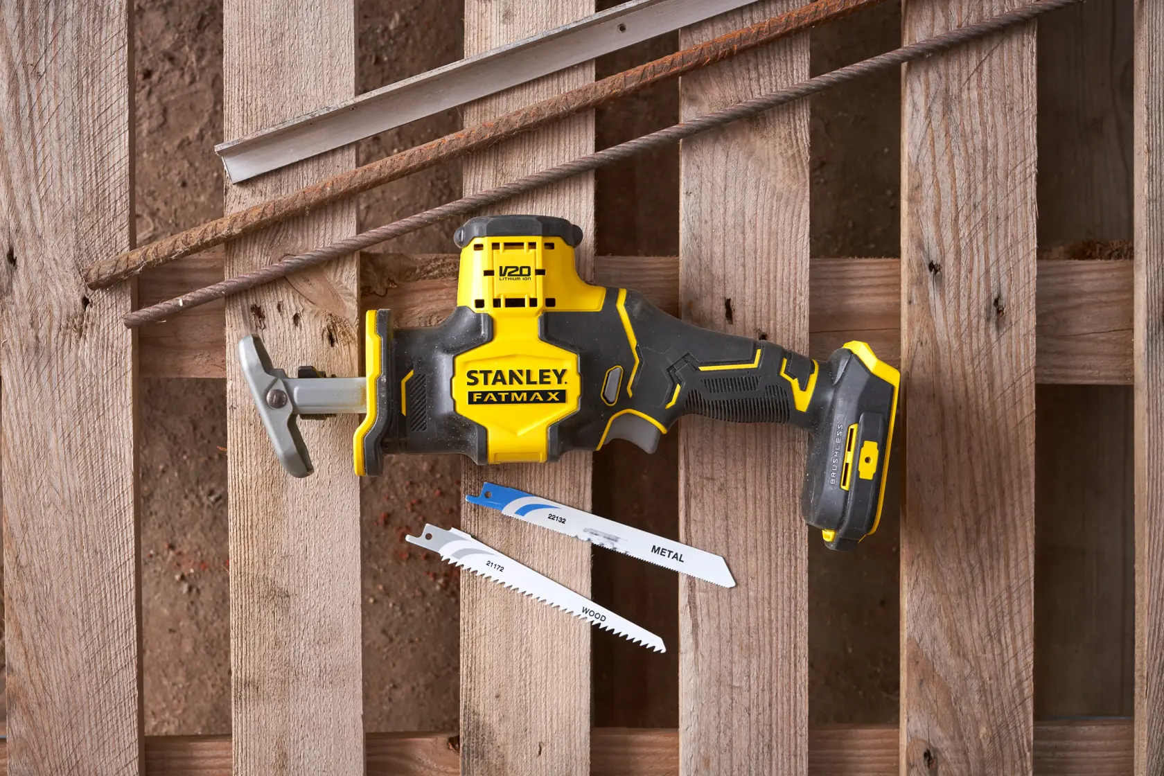 Stanley SFMCS305B reciprocating saw with yellow and black design shown with two saw blades on wood background.