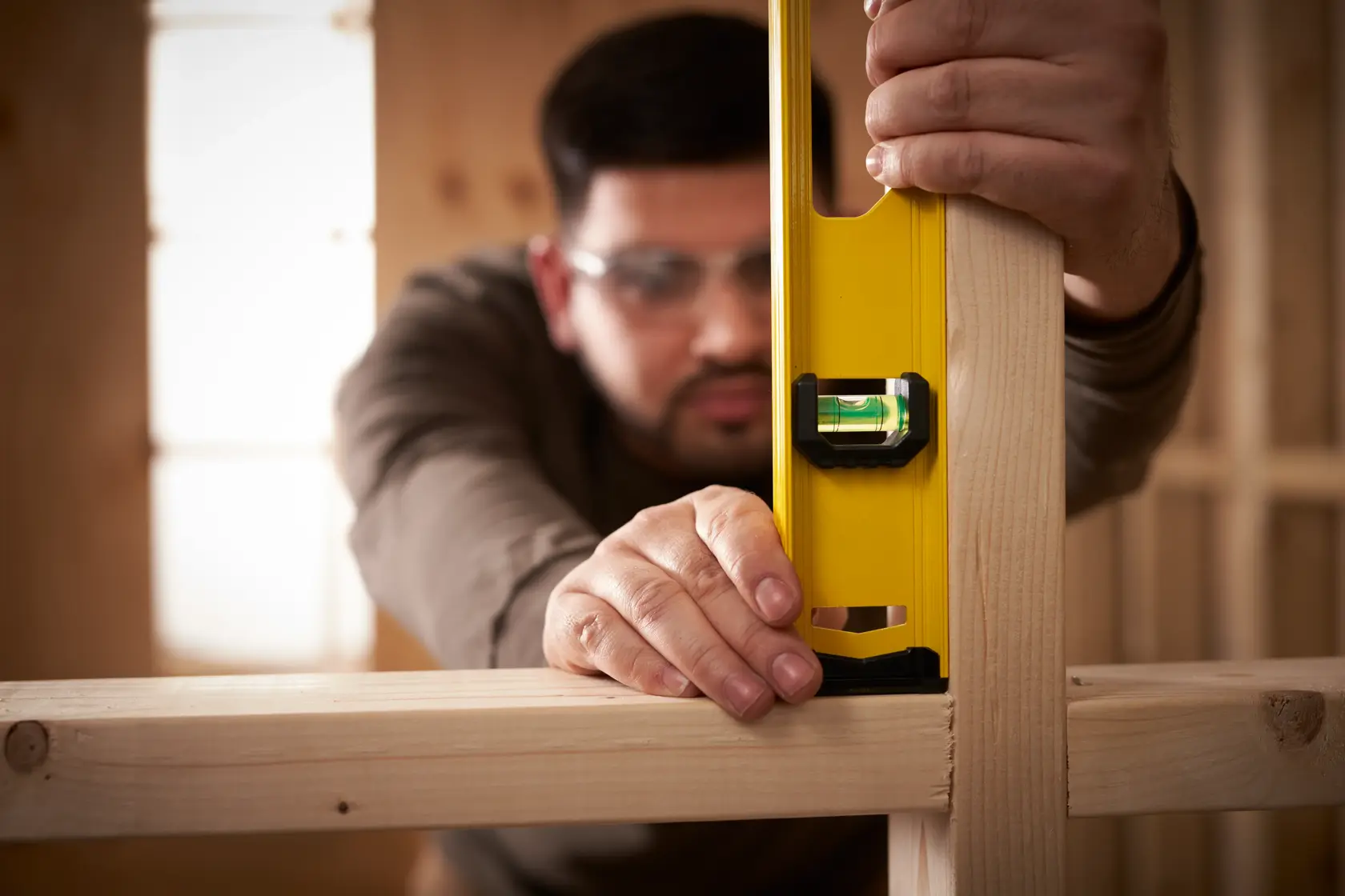 STANLEY 0-42-076 photography of yellow spirit level in use on wooden frame construction.
