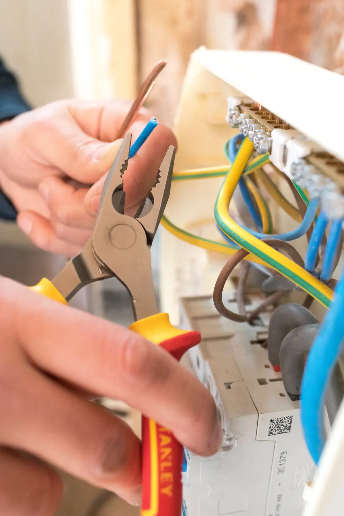 Photo of STANLEY 0-84-000 pliers being used to grip wire near electrical panel.