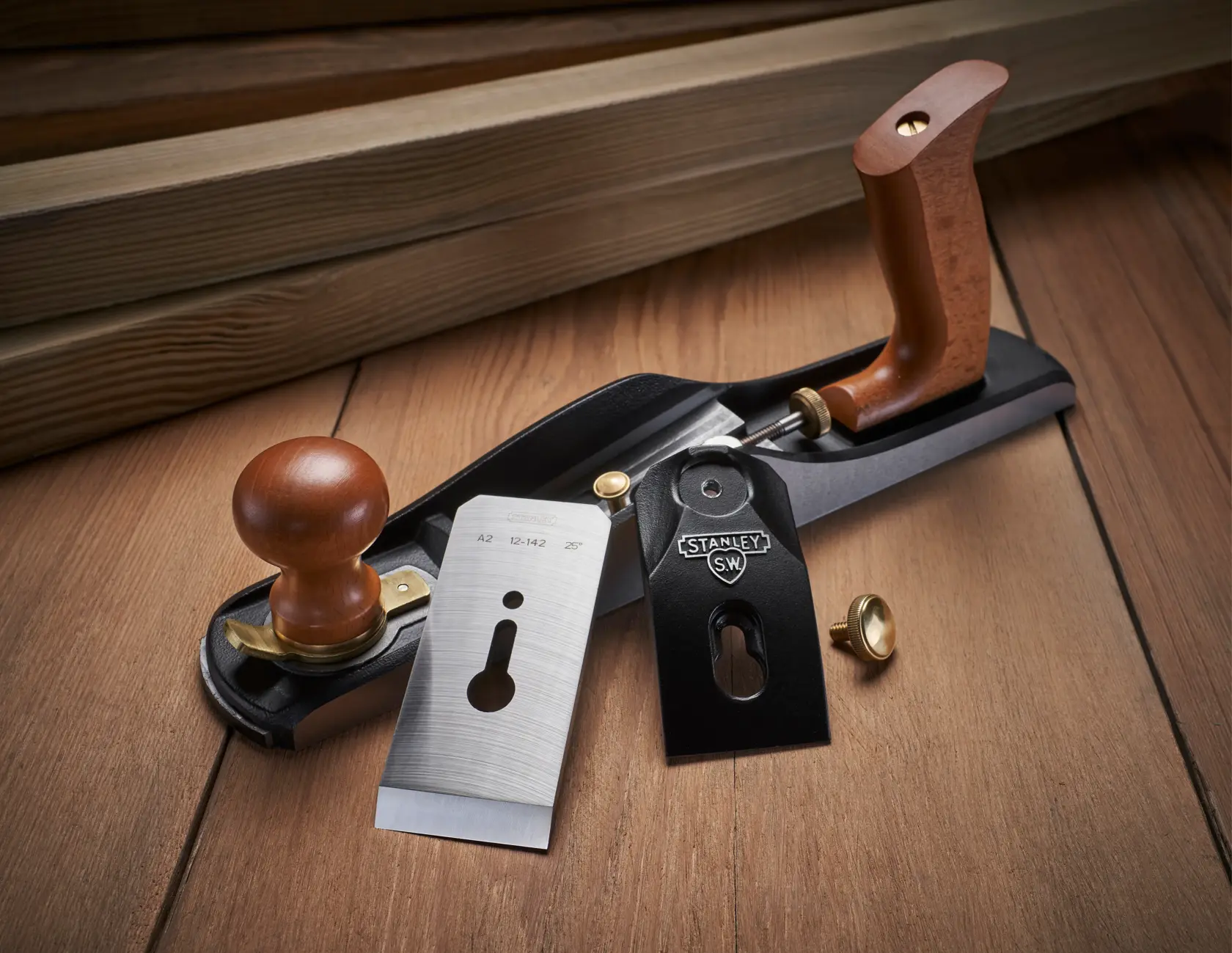 STANLEY 1-12-137 hand plane with wooden handles and metal parts, shown disassembled on wood surface.