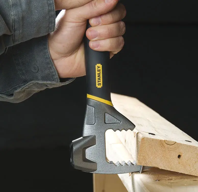 STANLEY 1-55-119 hammer in use on wood, close-up photography showing ergonomic grip.