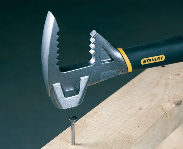 STANLEY 1-55-119 adjustable wrench with black and yellow handle gripping a nail in wood, side angle.