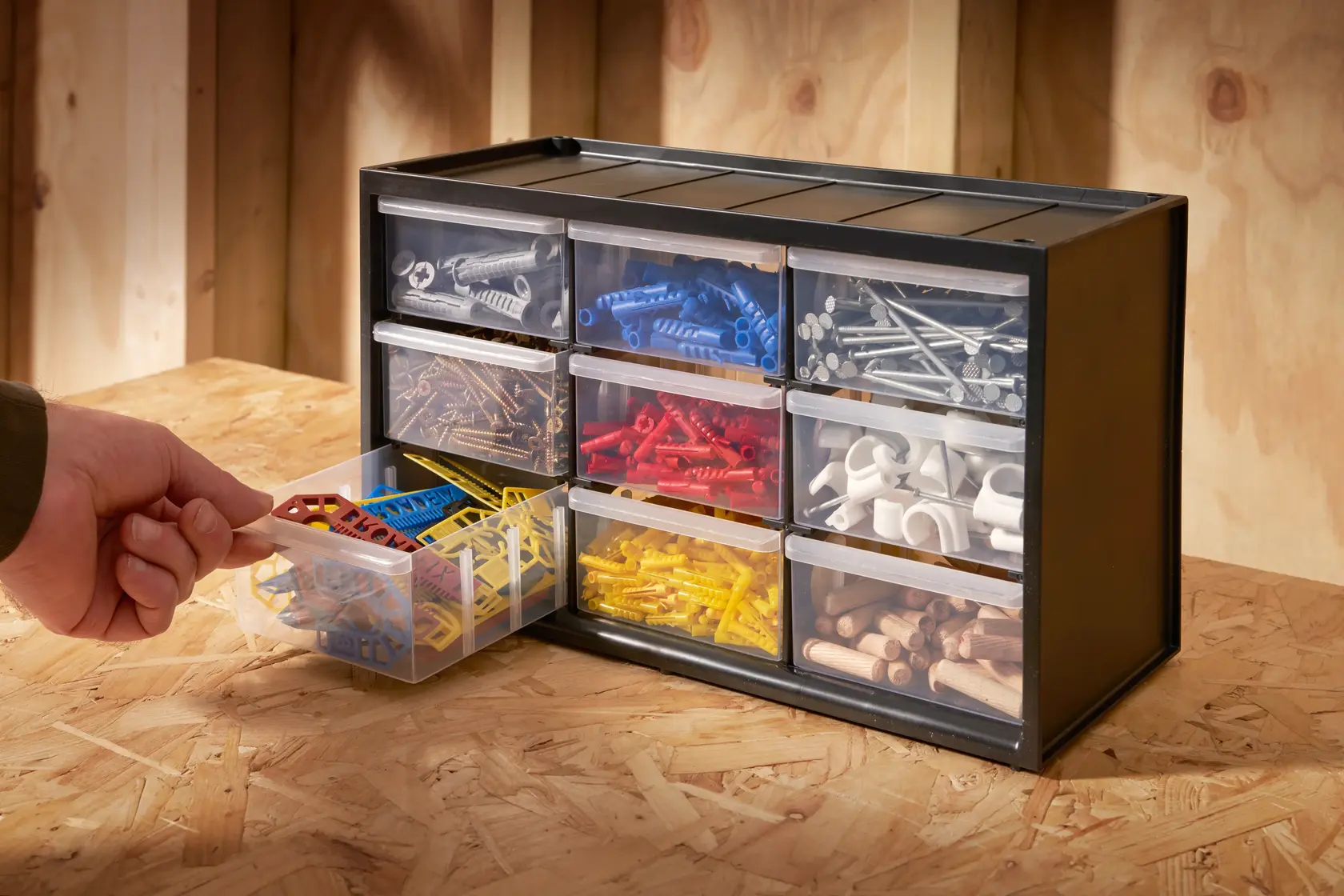 STANLEY 1-93-978 small parts organizer with open drawer filled with assorted colored fasteners, photo on workbench.