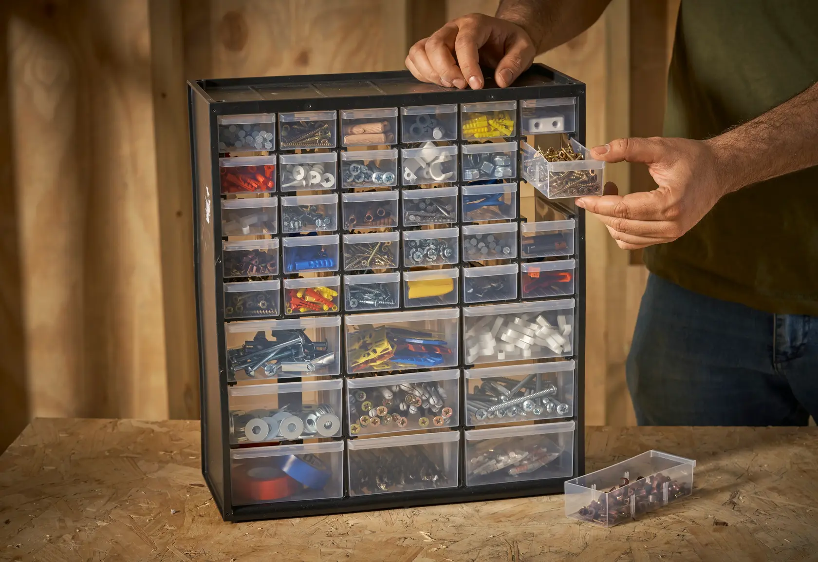 STANLEY 1-93-981 organizer cabinet with clear drawers filled with assorted hardware, angled view.