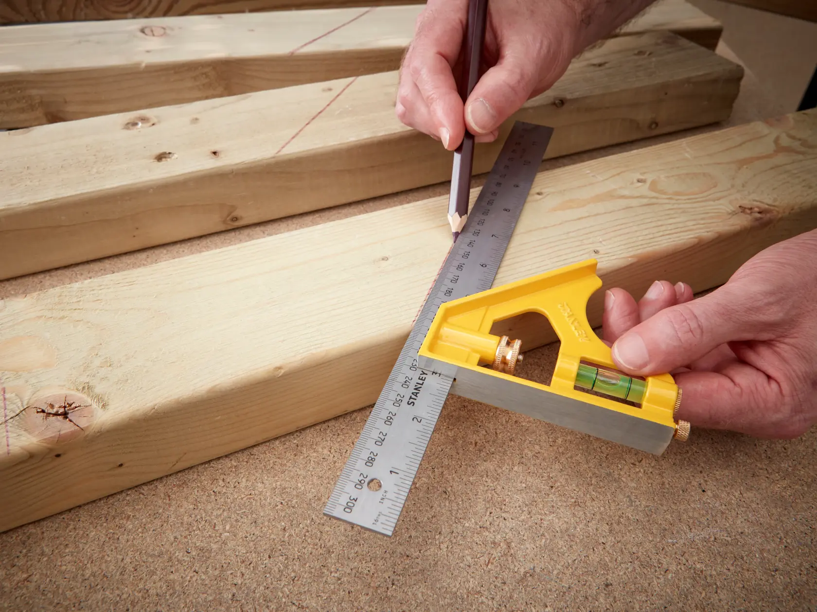 Photo of STANLEY 2-46-028 combination square used to mark lines on wooden boards.