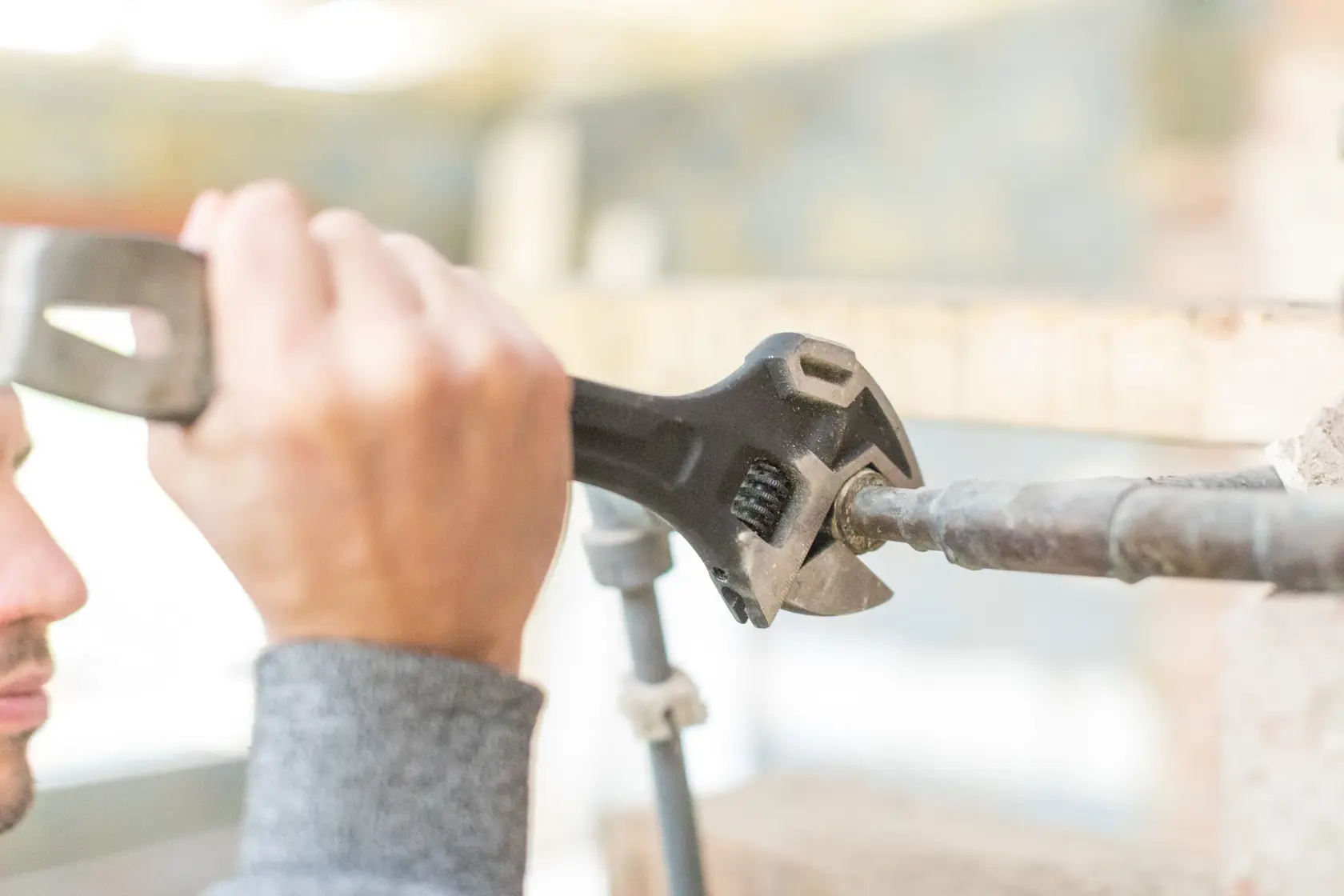 STANLEY FMHT0-75081 adjustable wrench used on a metal pipe, close-up photography.