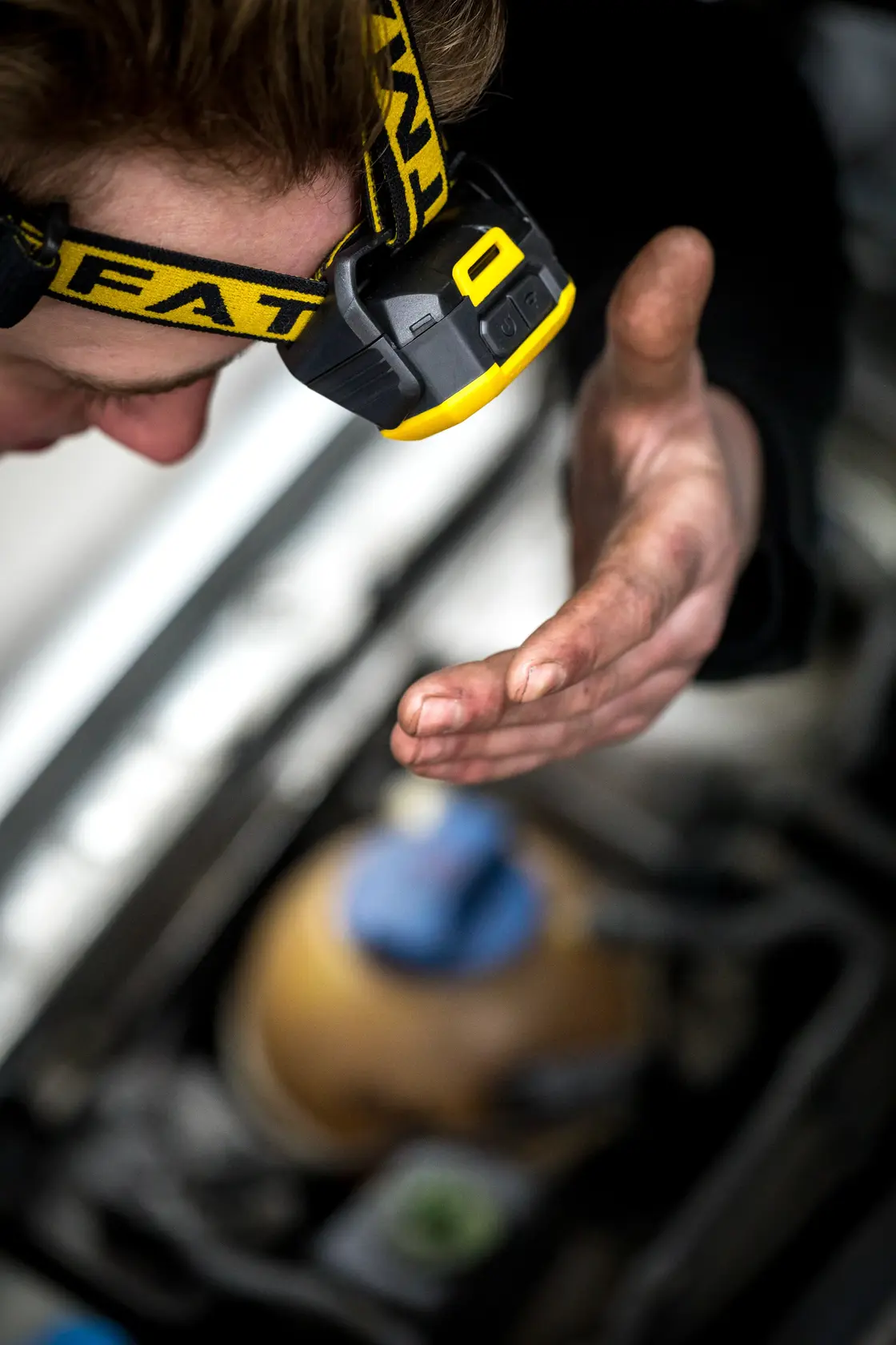 STANLEY FMHT81509-0 headlamp on person working, yellow and black design, photography close-up.