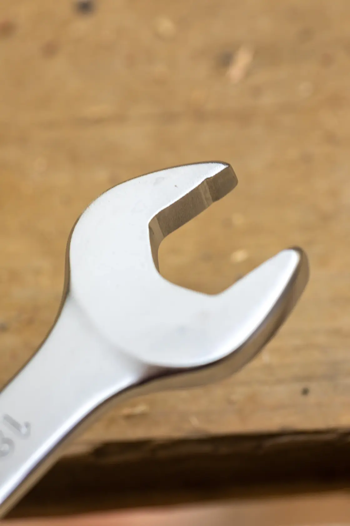 STANLEY FMMT13033-0 open-end wrench close-up on wood surface, showing polished steel finish.