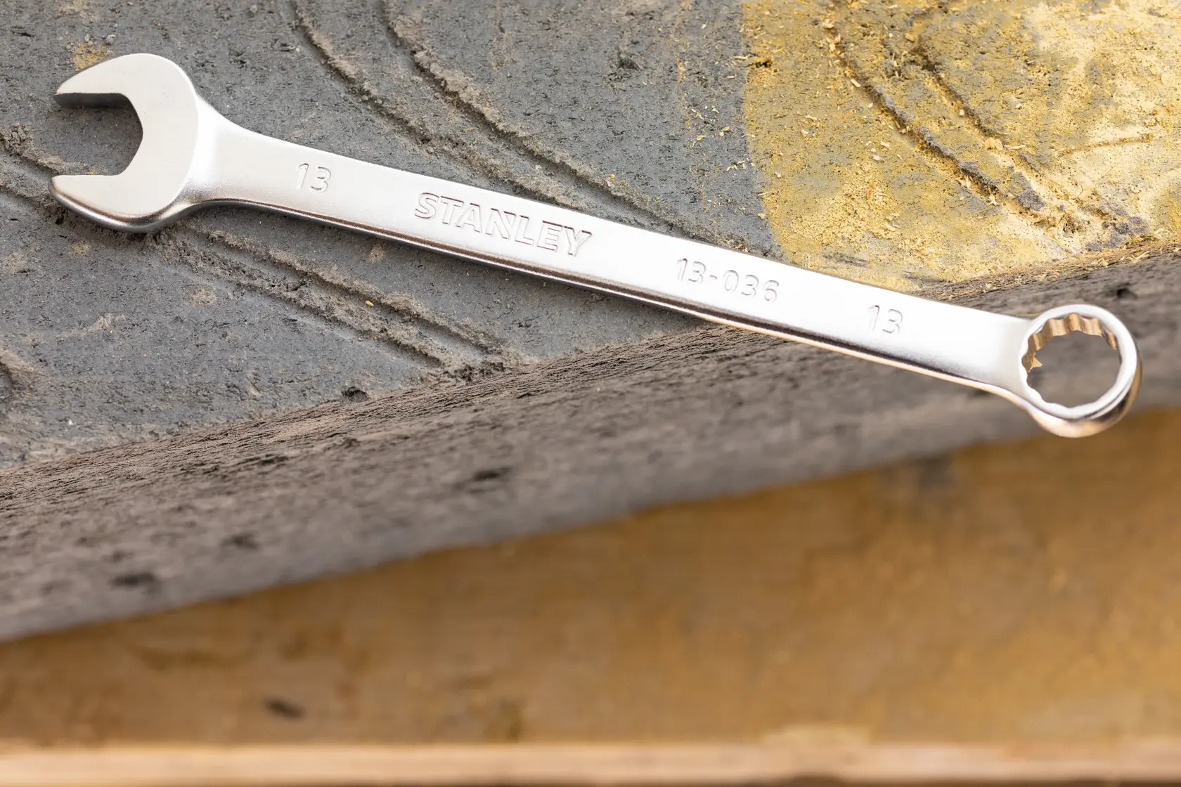 STANLEY FMMT13033-0 combination wrench, silver finish, photographed on concrete surface.