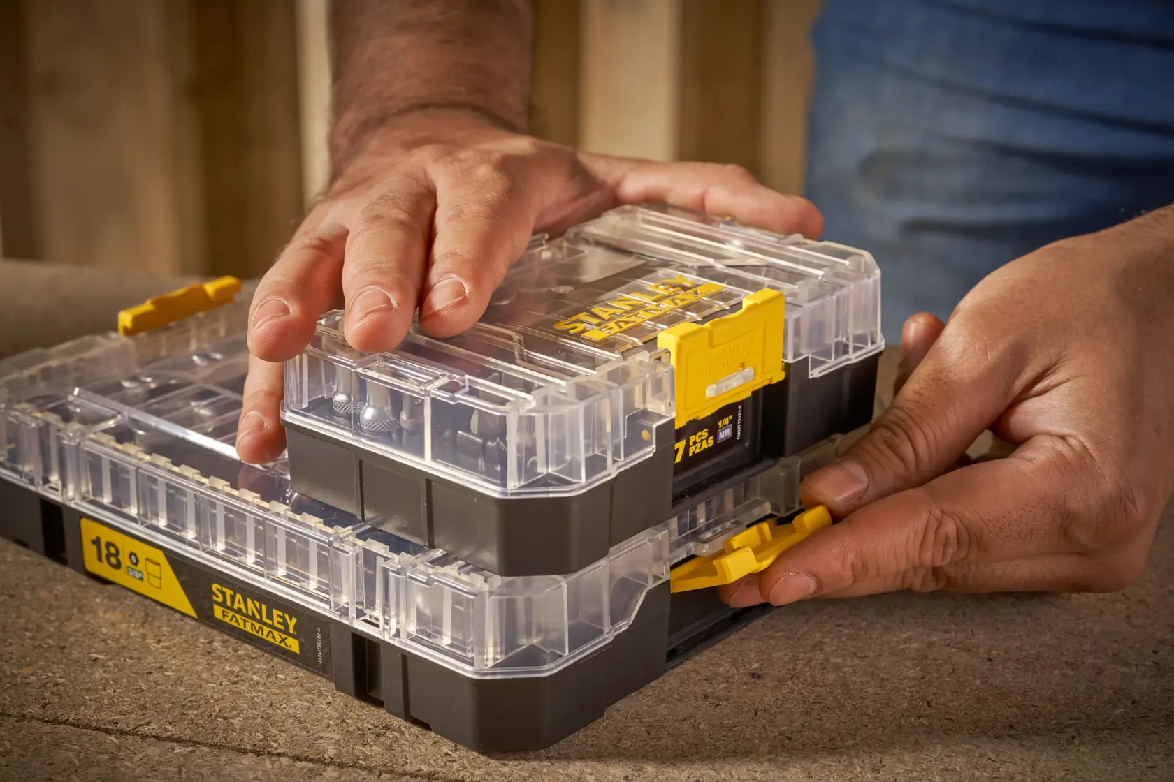 Photo of STANLEY FMMT19101-0 small parts organizer with clear lid, black and yellow latches, shown being opened.