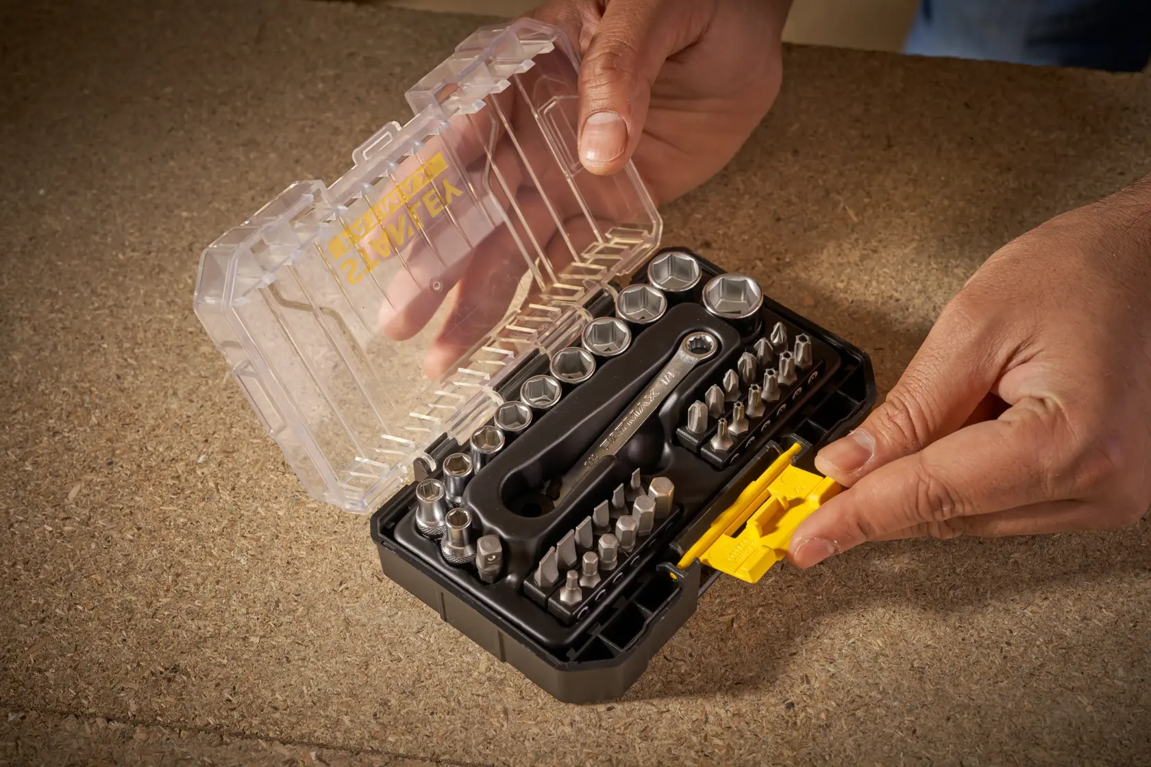 STANLEY FMMT19101-0 ratchet socket and bit set in clear case held by hands, top view