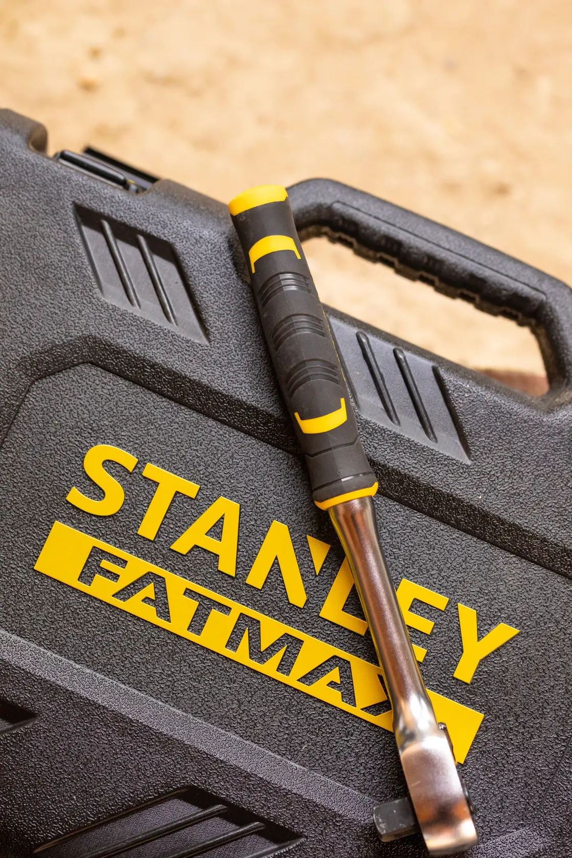 STANLEY FMMT82826-1 hand tool with black and yellow handle on STANLEY FATMAX case, angled top view.