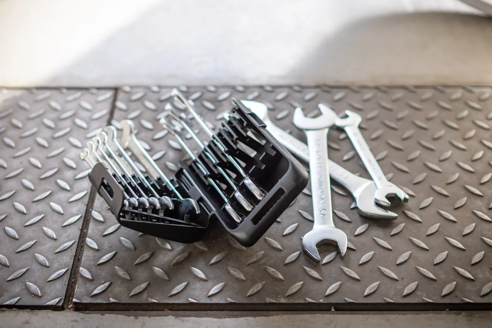 STANLEY FMMT82902-0 wrench set with black case on diamond plate floor, wrenches arranged in holder and three loose.