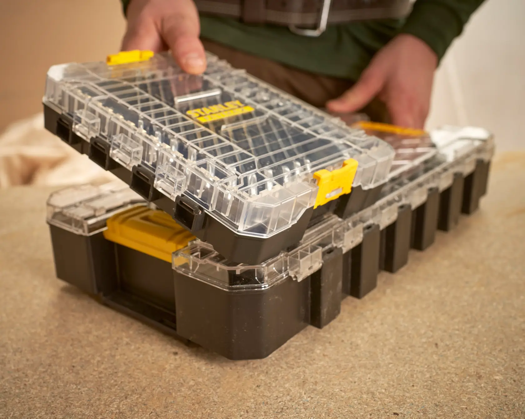 STANLEY FMMT98104-0 black and clear plastic organizer box with yellow latches, shown in use.