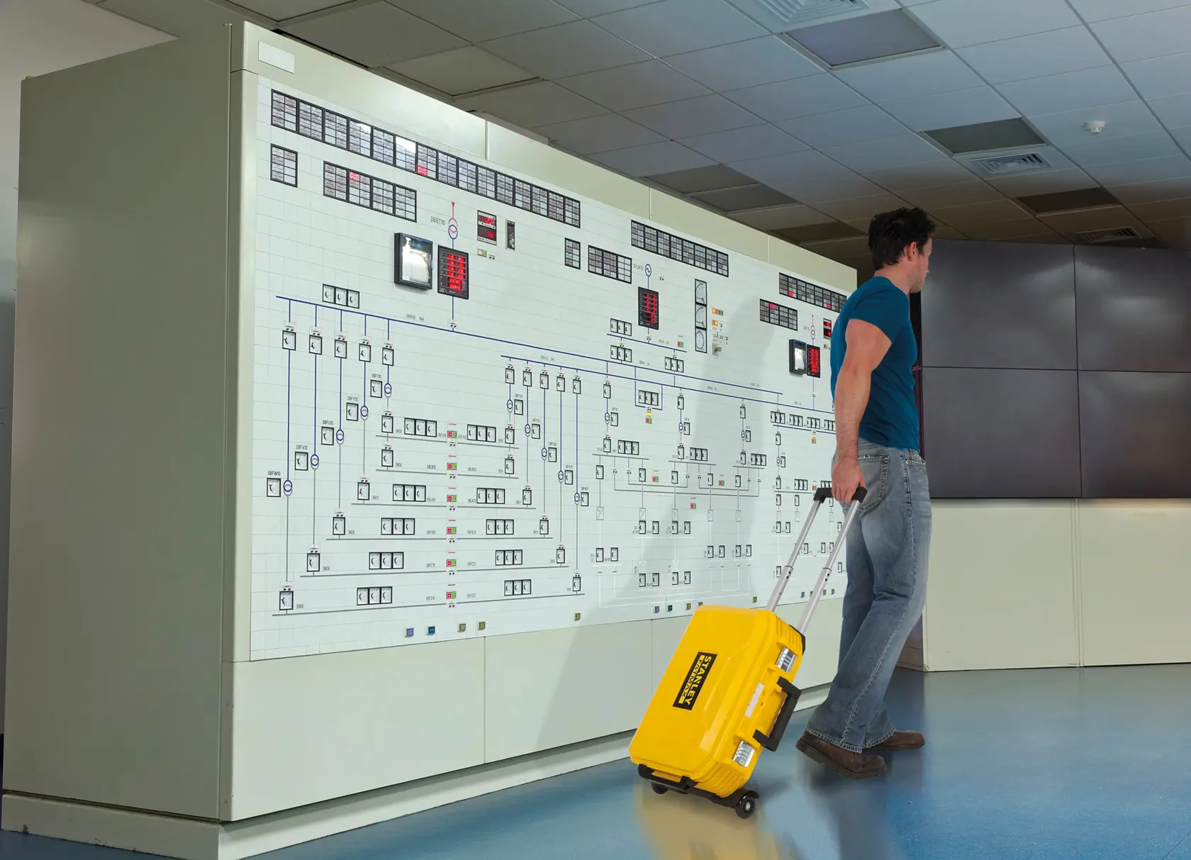STANLEY FMST1-71943 yellow rolling tool case with handle, indoor control room setting.