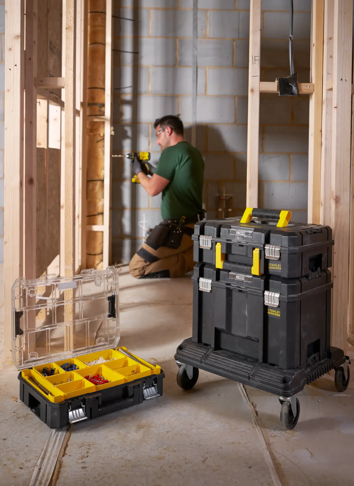 STANLEY FMST1-71972 rolling tool storage and organizer box set in jobsite setting, yellow and black.