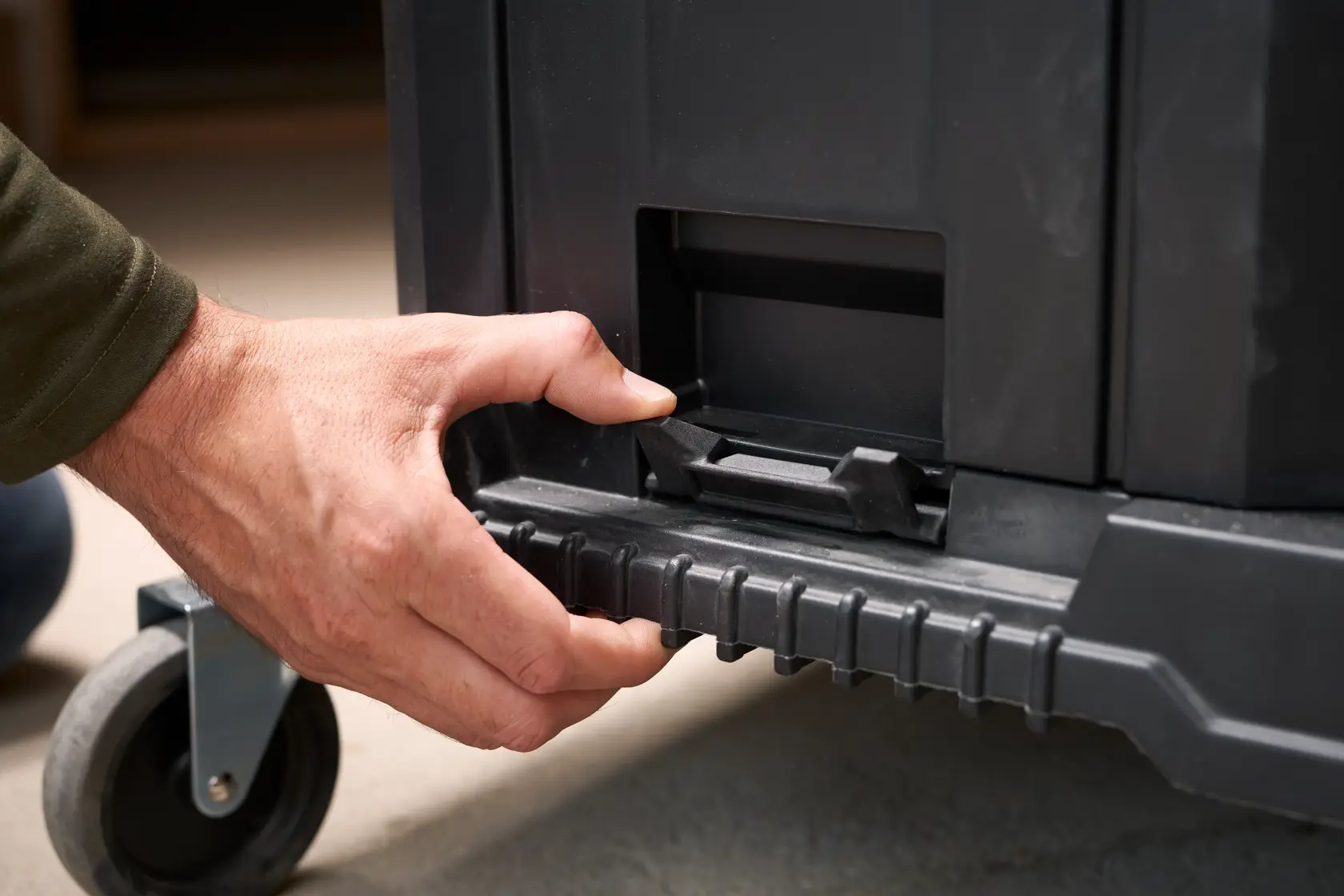 STANLEY FMST1-71972 wheeled toolbox close-up, hand unlocking latch, front angle.