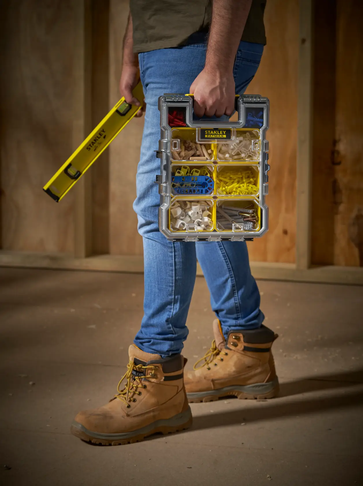 STANLEY FMST1-72378 organizer box with compartments, handheld, shown with level tool, photography.