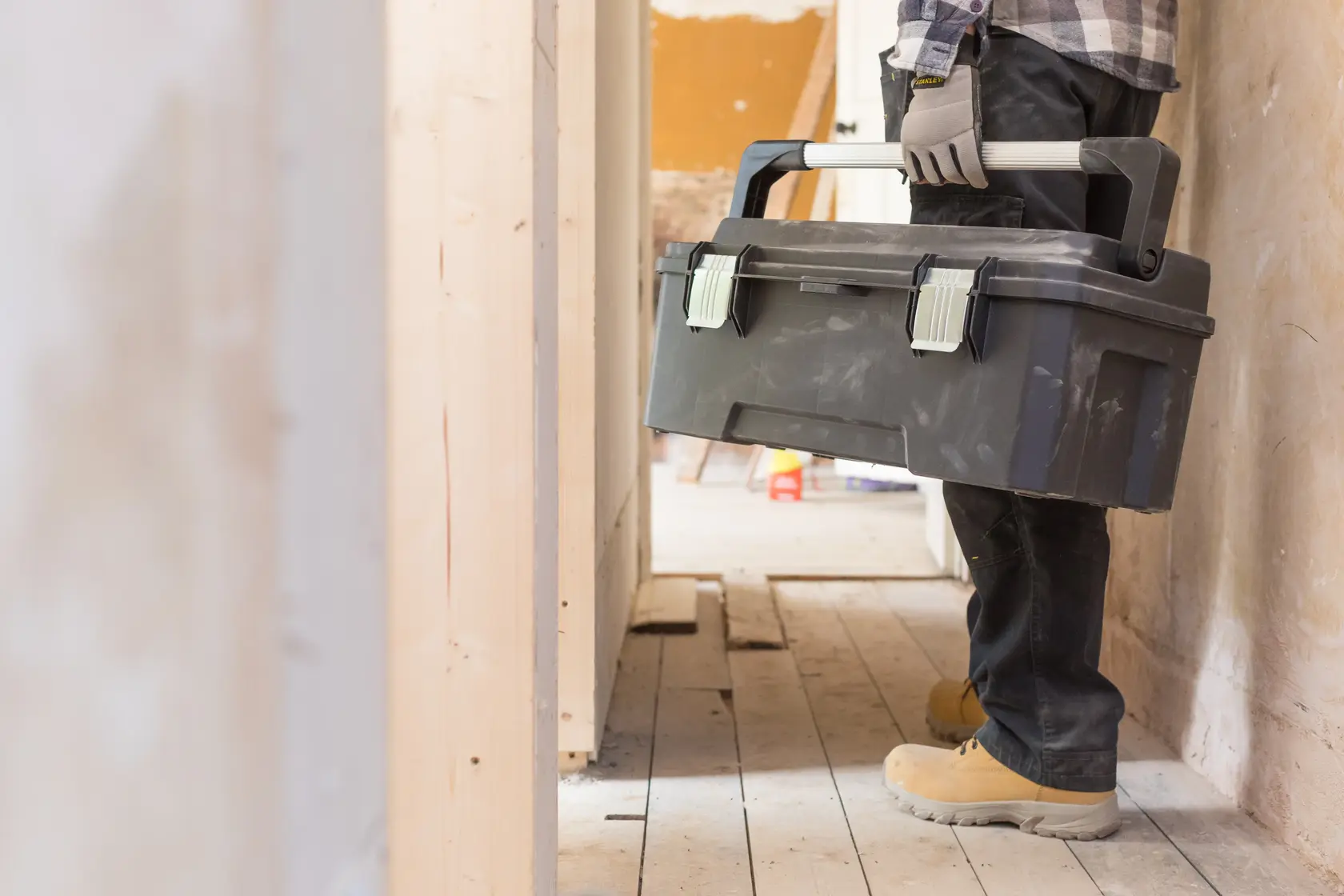 STANLEY FMST1-75791 toolbox being carried by a worker on a construction site.