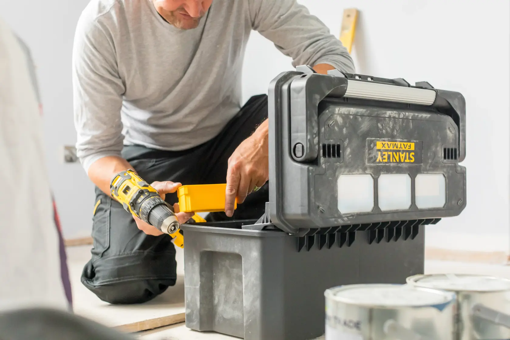 Photo of STANLEY FATMAX FMST1-75792 toolbox in use, open on the floor with tools inside.