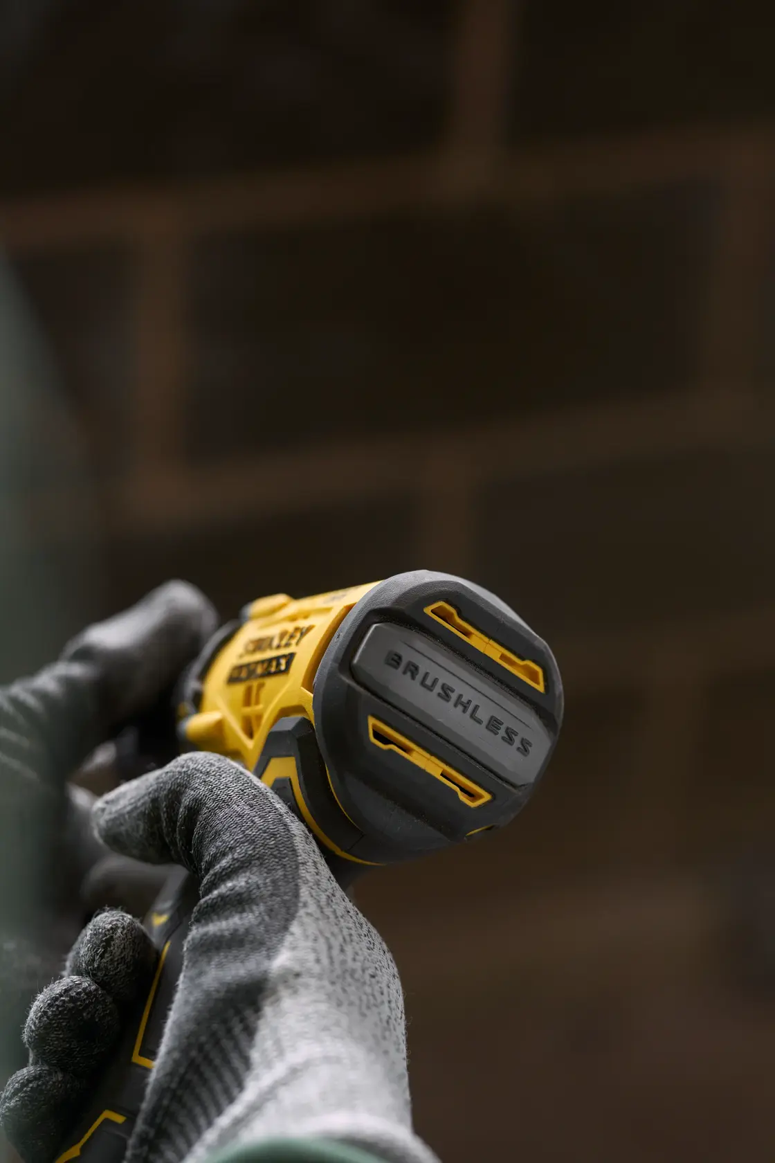 STANLEY SFMCD715D1K brushless cordless drill, close-up view in gloved hands.