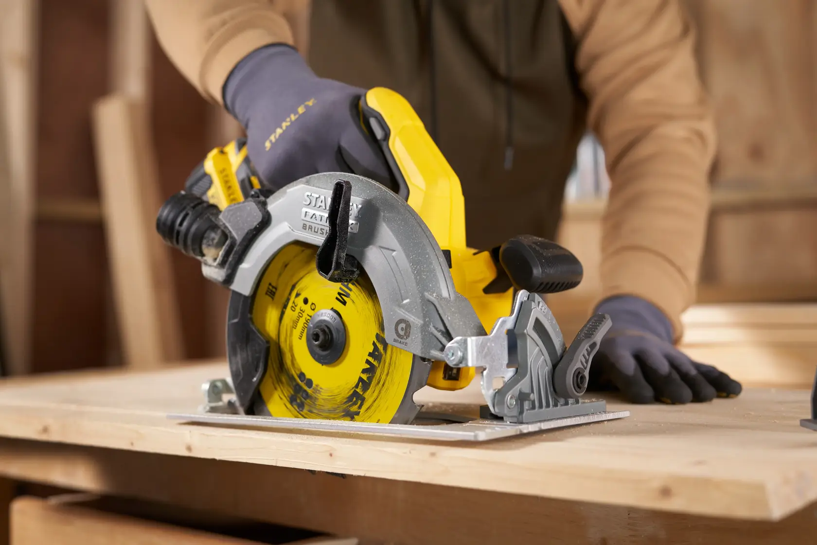 STANLEY STA13030 circular saw in use cutting wood, close-up view in workshop setting.