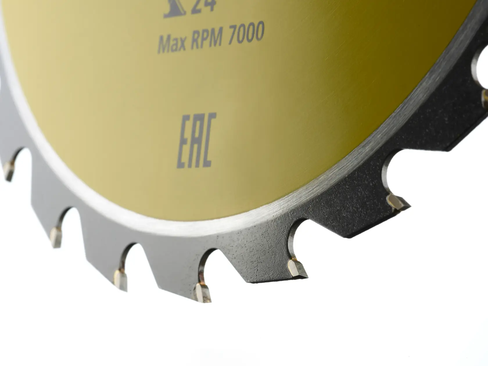 Close-up of a circular saw blade with sharp teeth and yellow center, showing speed rating and markings.