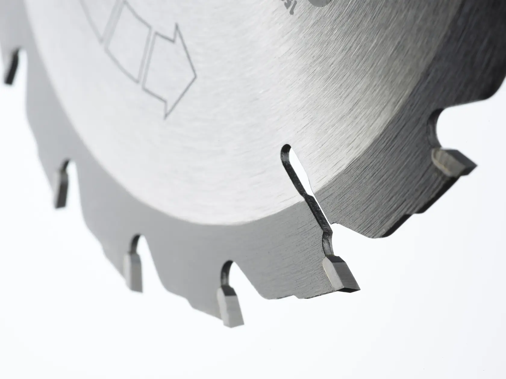 Close-up of a silver circular saw blade showing sharp teeth and directional arrow.