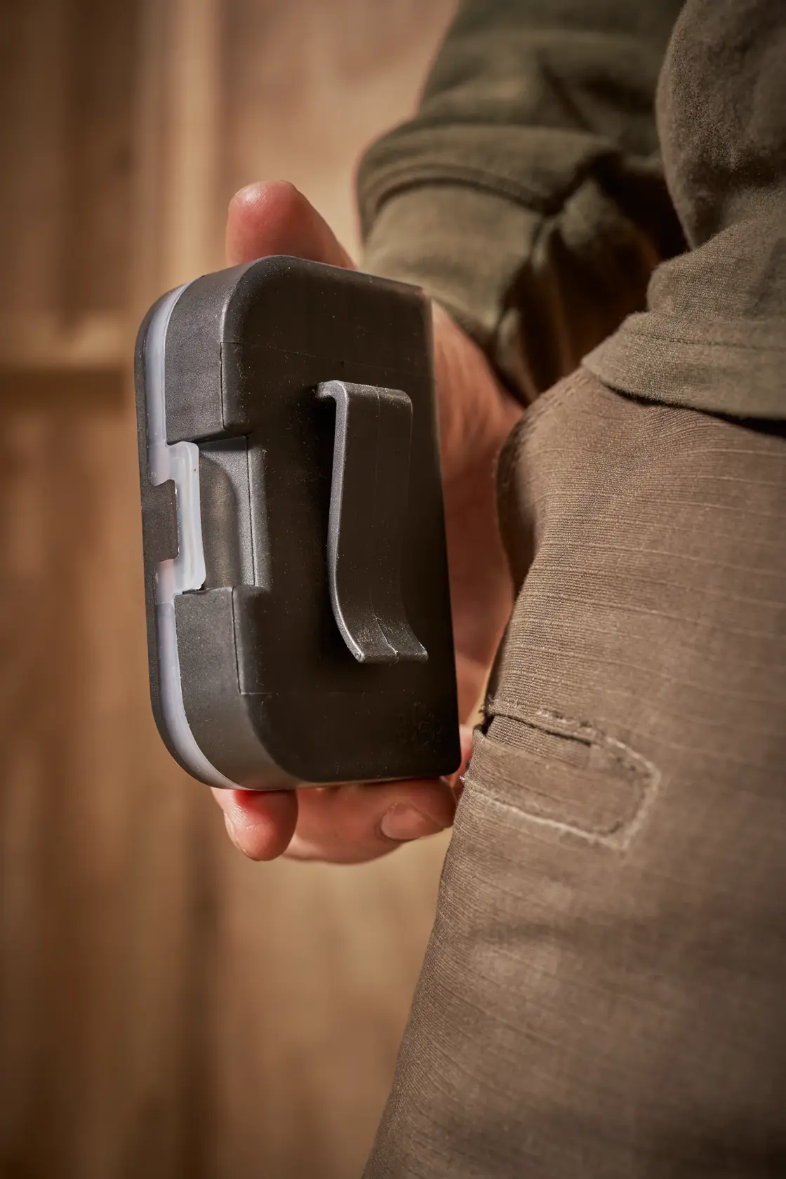 STANLEY STA60490 black compact utility case with belt clip, handheld, close-up photography.