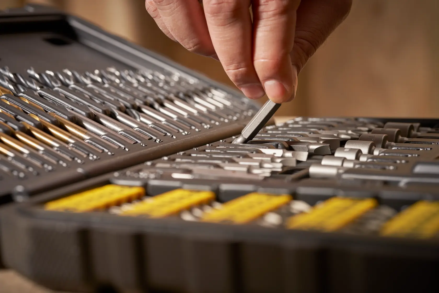 STANLEY STA88548 drill and bit set in case, close-up of hand selecting a bit from organized slots.