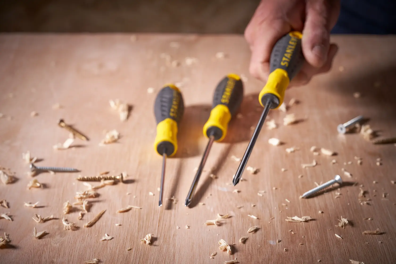 STANLEY STHT0-60335 screwdriver set with yellow and black handles on a wooden surface with screws.