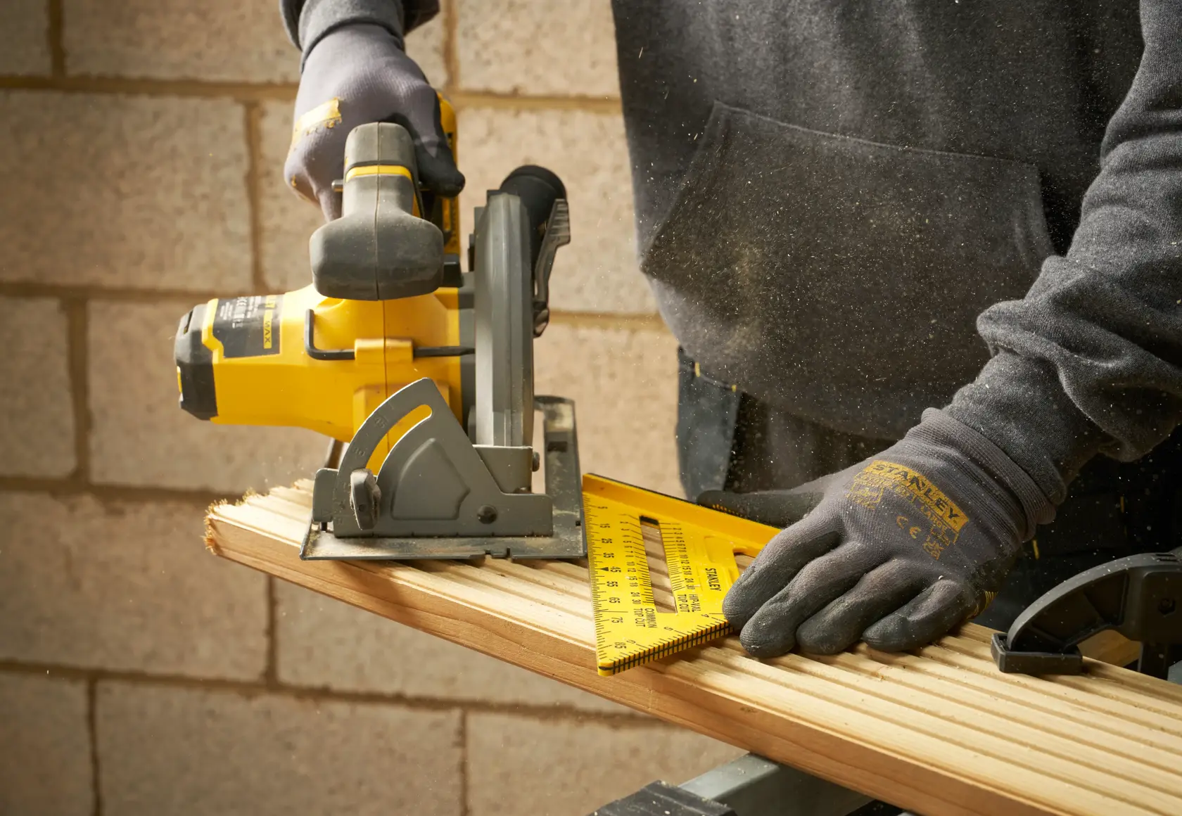 Photo of STANLEY STHT46010-0 square ruler in use for woodworking, yellow ruler held against wood.