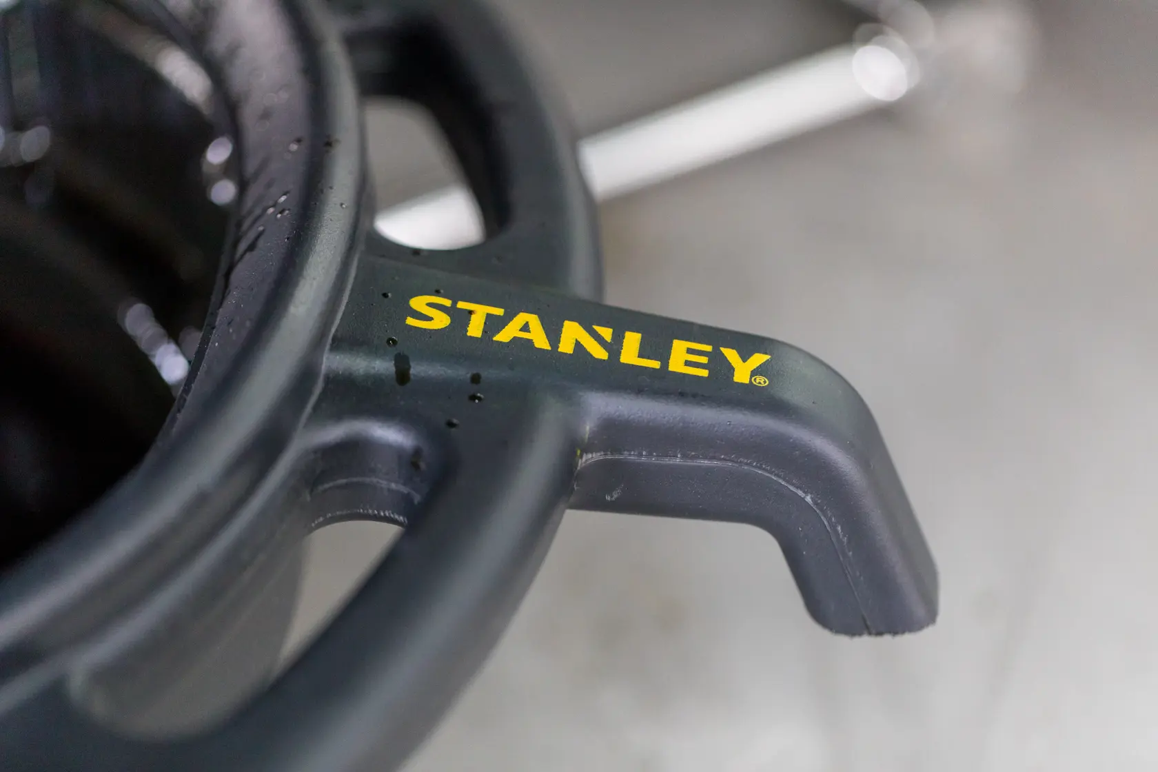 Photo of STANLEY STHT80878-1 black plastic tool handle with yellow STANLEY logo, close-up view.