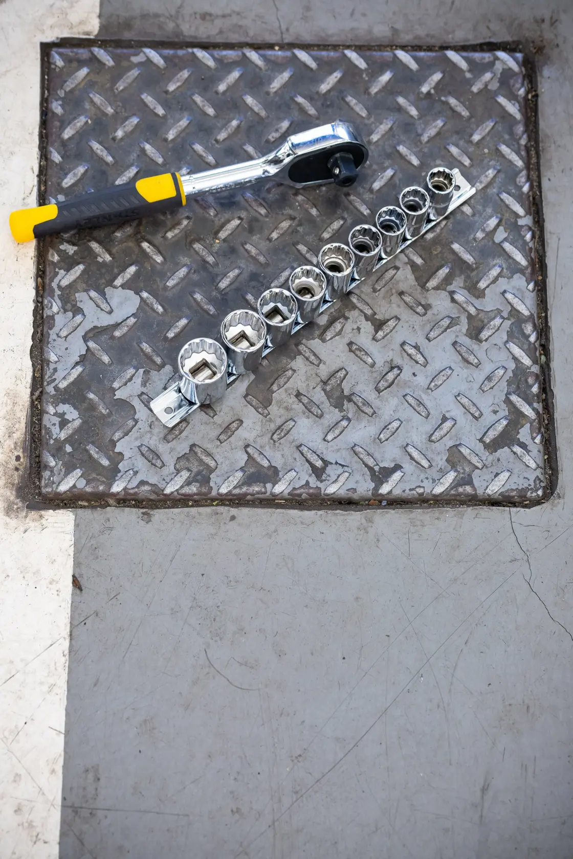 STANLEY STMT82666-0 ratchet and socket set photographed on metal surface.