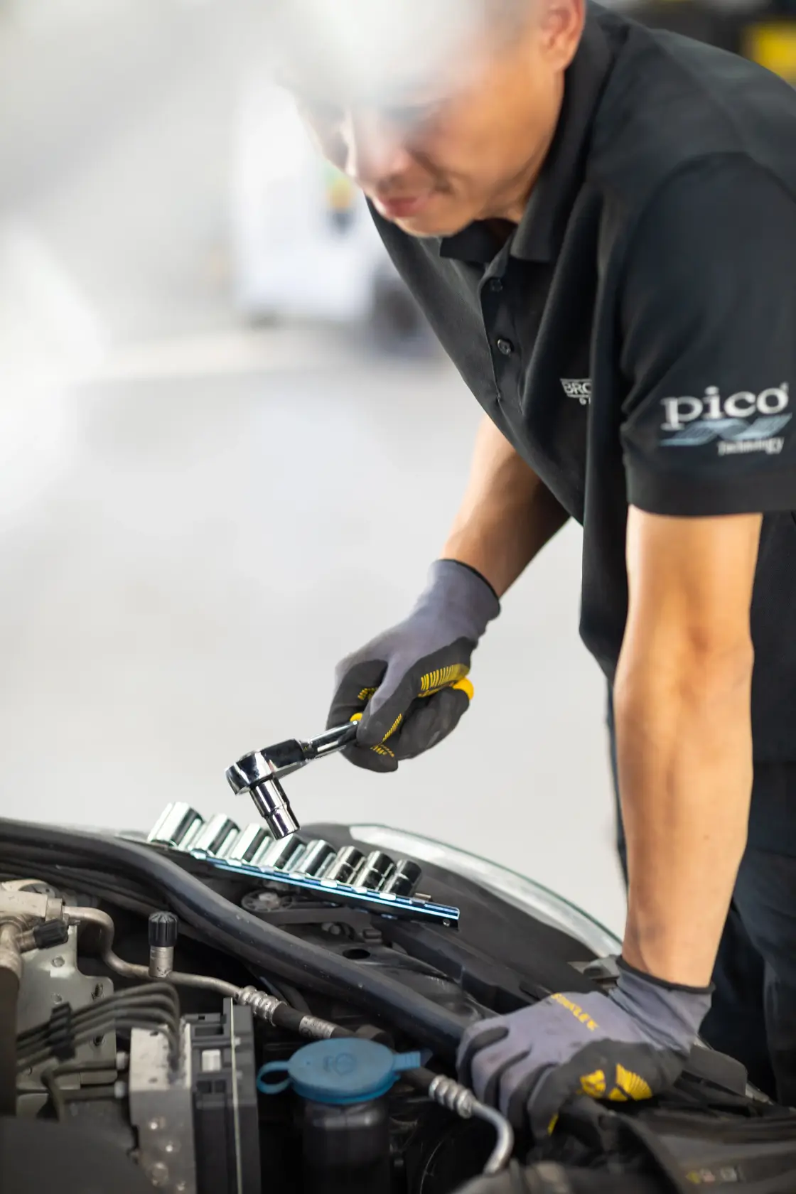 STANLEY STMT82671-0 socket wrench set in use by mechanic working on car engine.