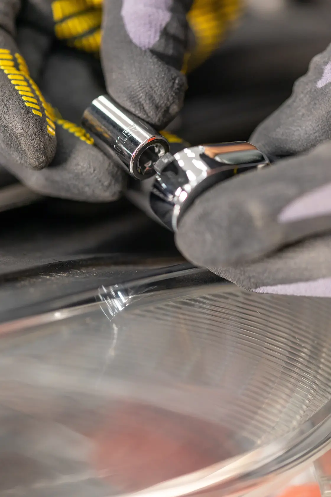 STANLEY STMT82829-1 socket being attached to a ratchet, close-up of gloved hands, product photography.