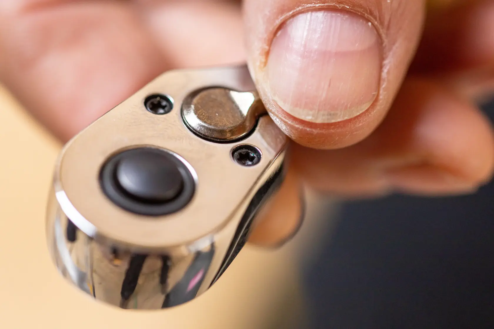 Close-up photo of a hand using a STANLEY STMT82829-1 ratchet wrench showing the switch mechanism.