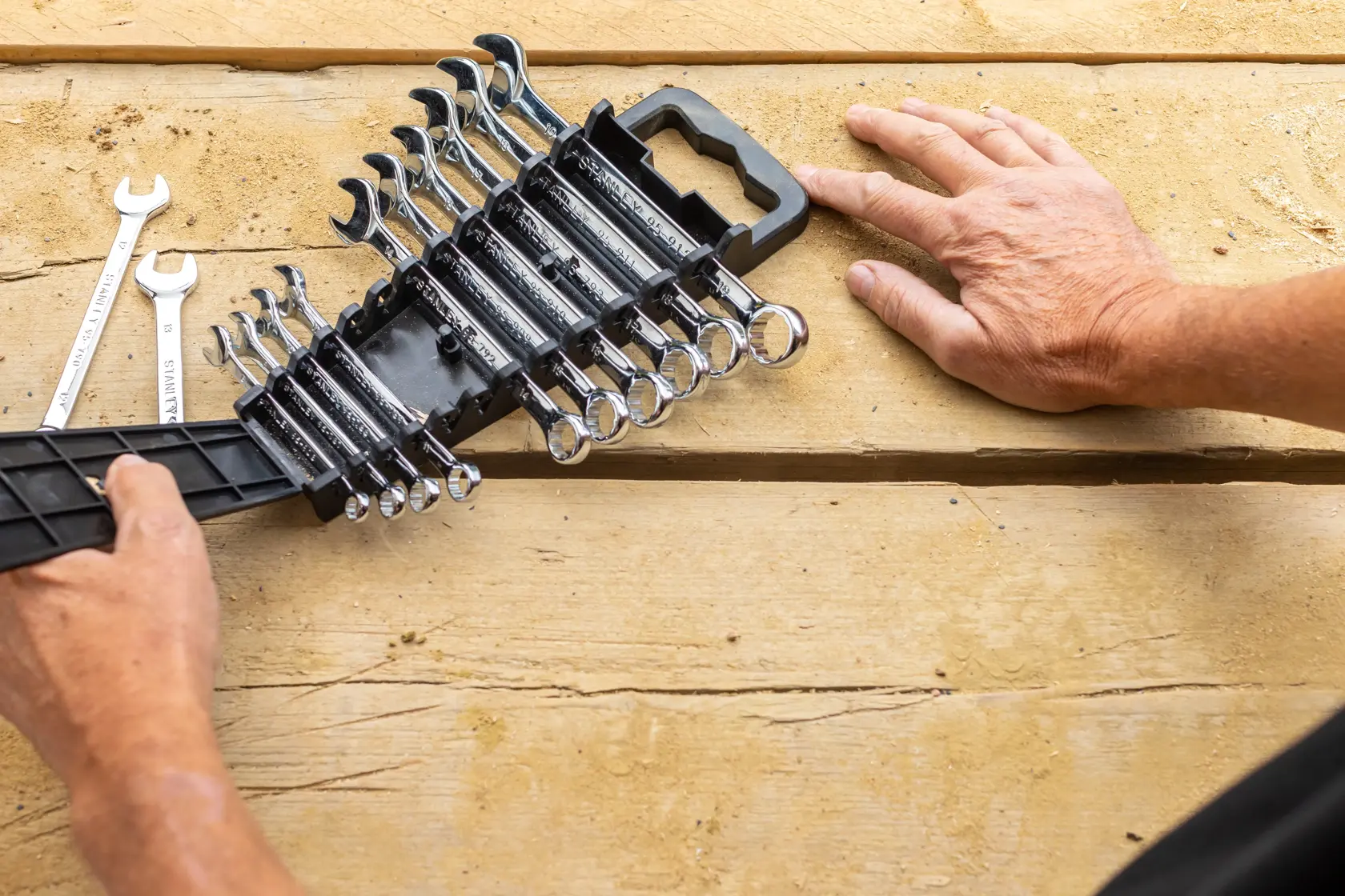 STANLEY STMT82843-0 wrench set with holder on wood surface, various sizes visible, top down angle.