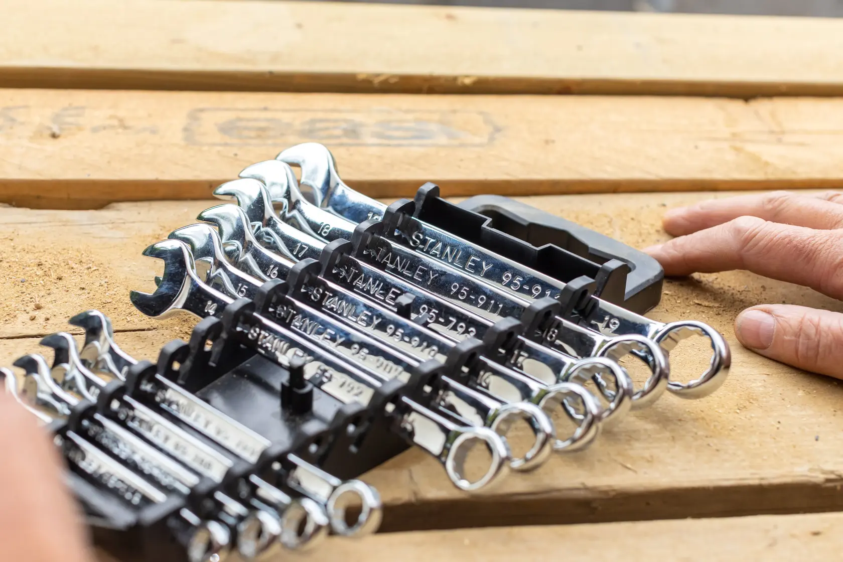 Photo of STANLEY STMT82843-0 wrench set in black holder on wooden surface, partially handled.
