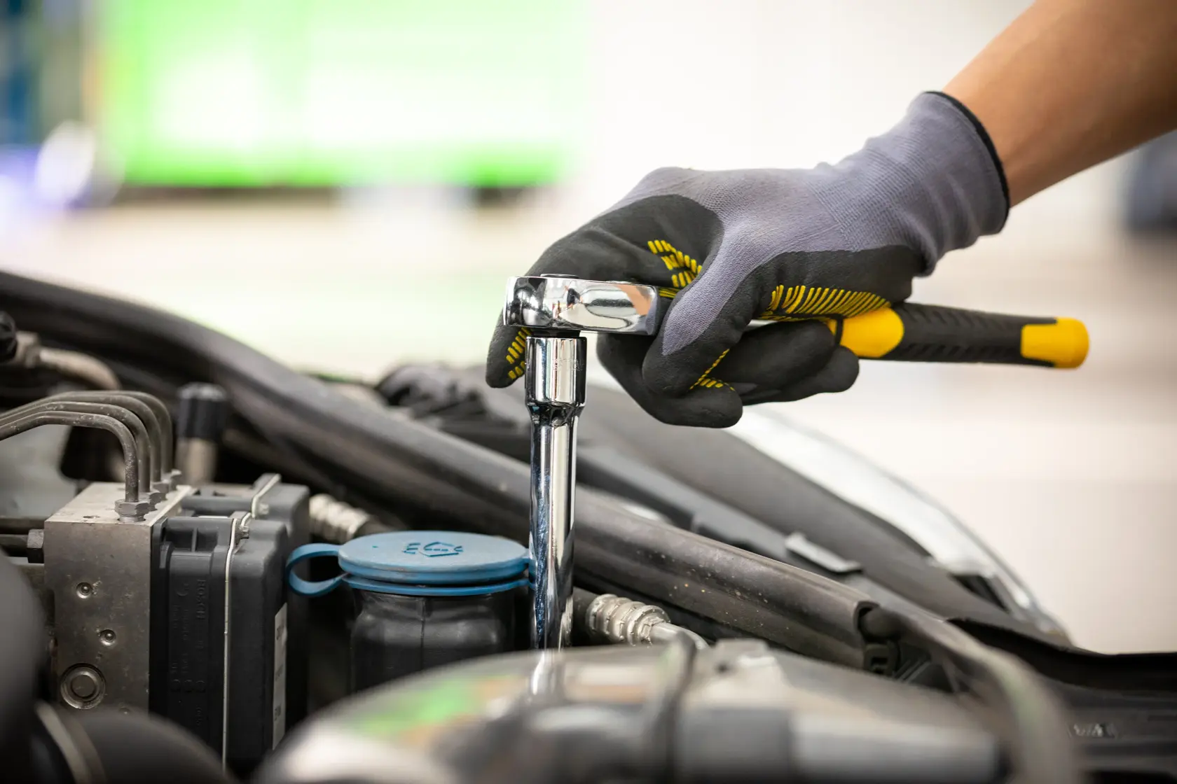 Stanley STMT86007-0 ratchet wrench in use on car engine, close-up photography.