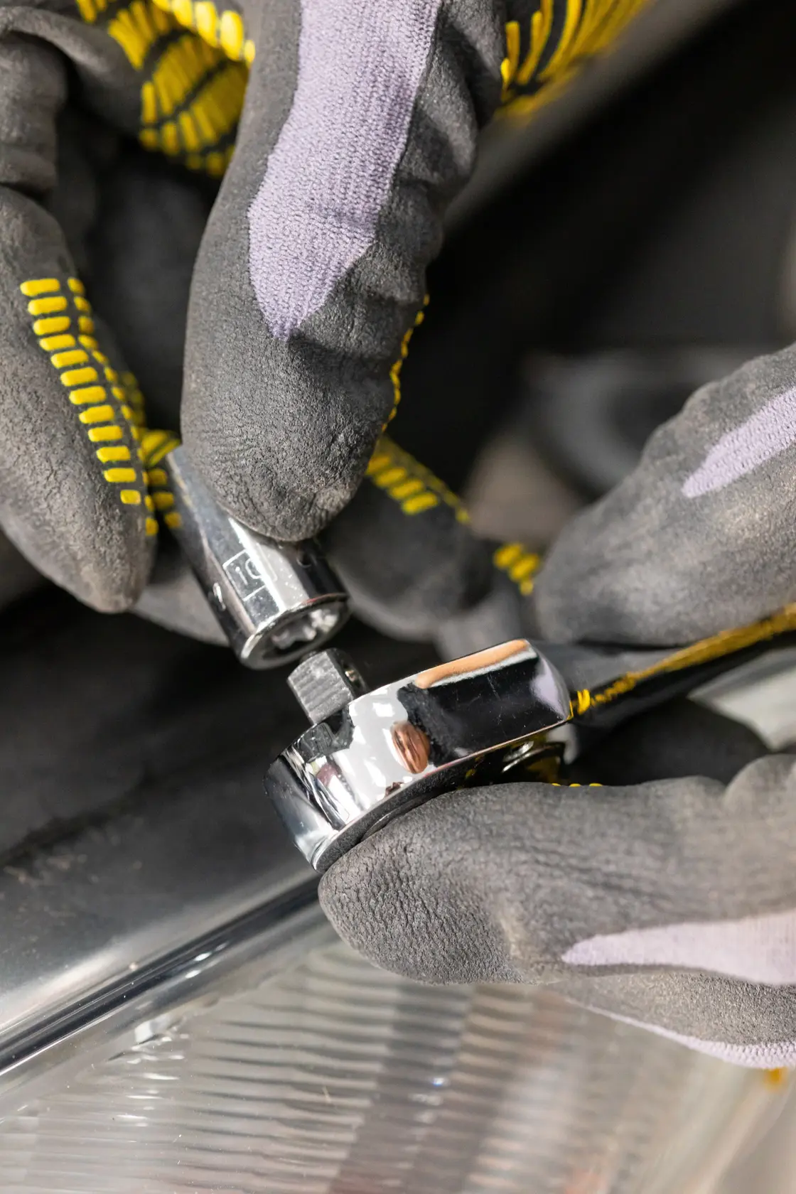 STANLEY STMT86103-0 photography of hand in glove attaching socket to chrome ratchet wrench.