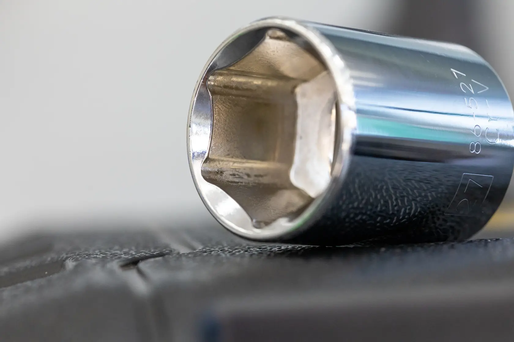 STANLEY STMT86112-0 chrome socket close-up, tool photography on black textured surface.