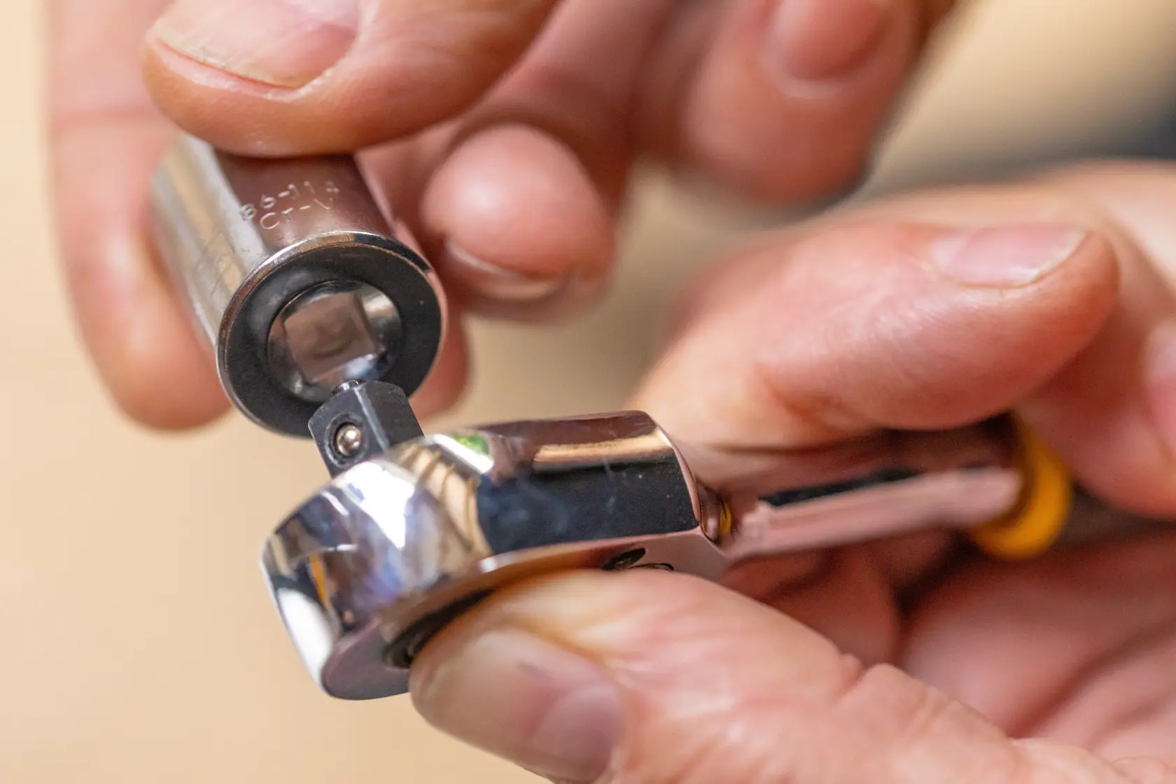 STANLEY STMT86112-0 photography of socket being attached to ratchet wrench close-up.