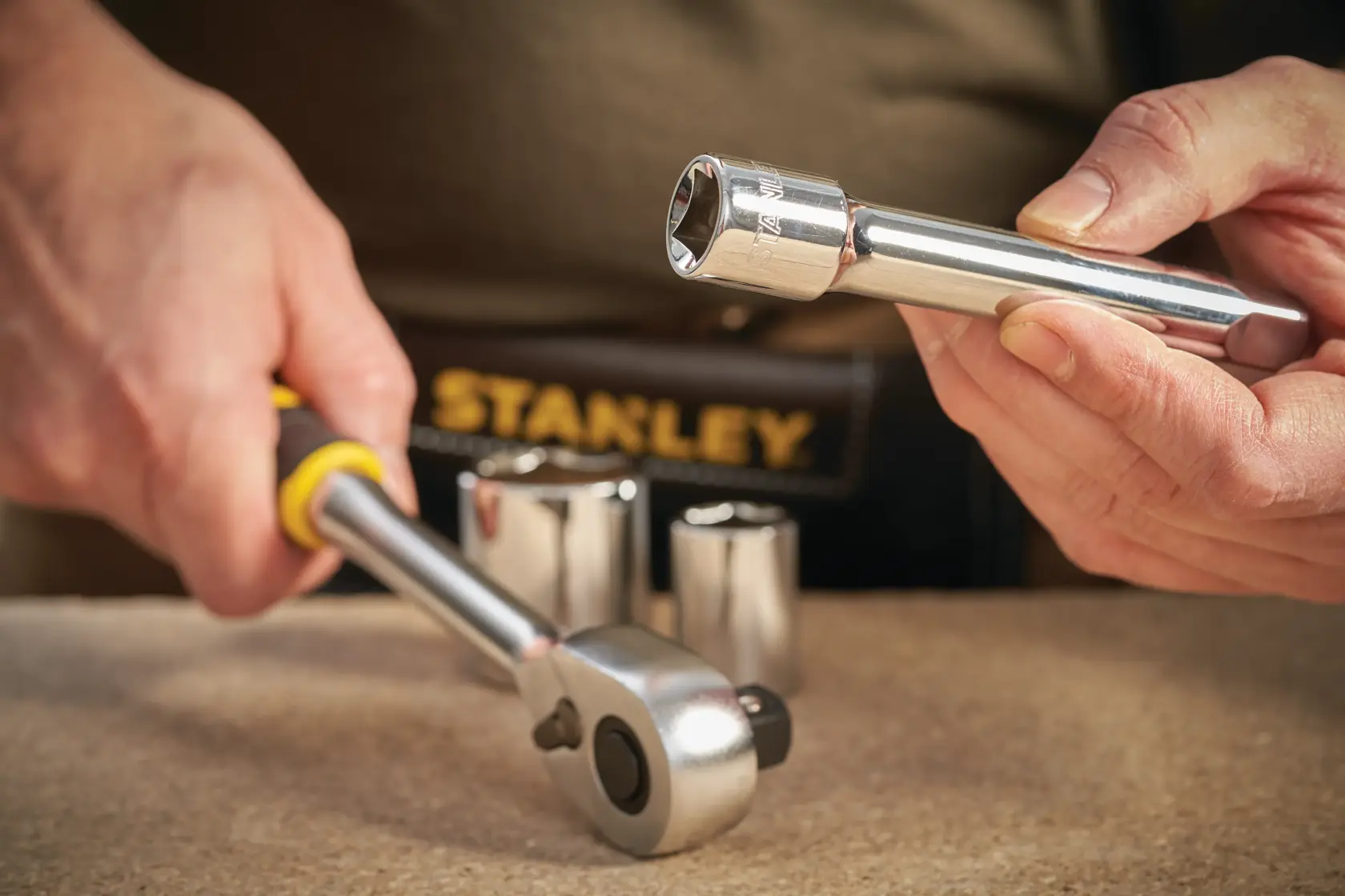 Stanley STMT86407-0 socket wrench set on table, close-up, with chrome sockets and ratchet tool.