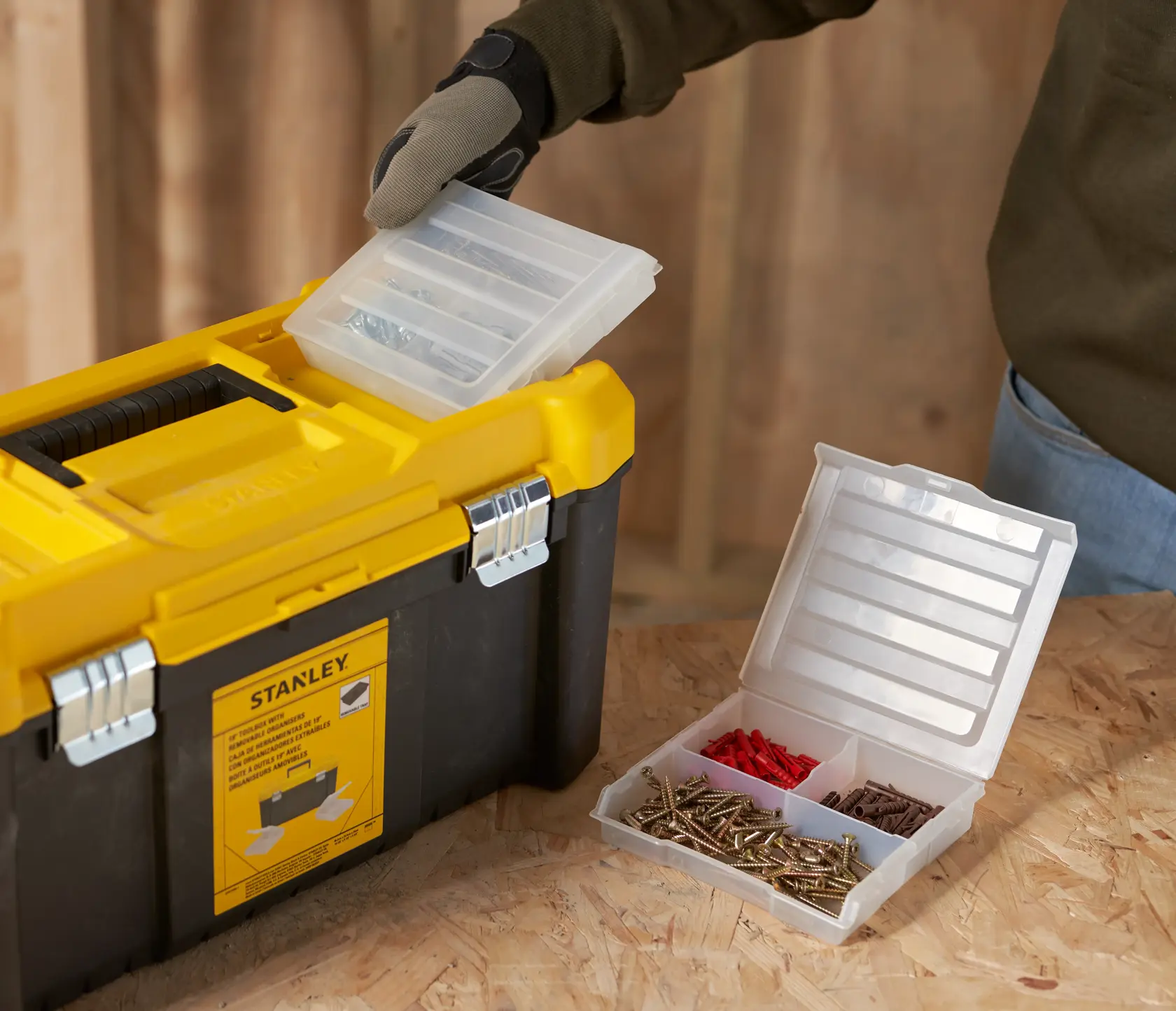 STANLEY STST75787-1 toolbox with removable organizer tray, yellow and black, shown in workshop setting.
