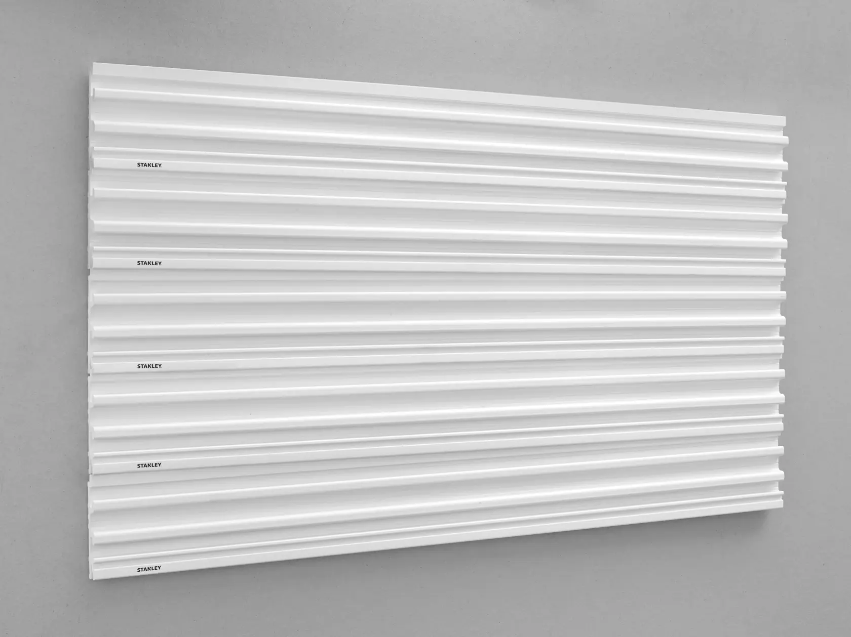 STANLEY STST82602-1 slatwall panel, white, wall-mounted, photographed from front angle.
