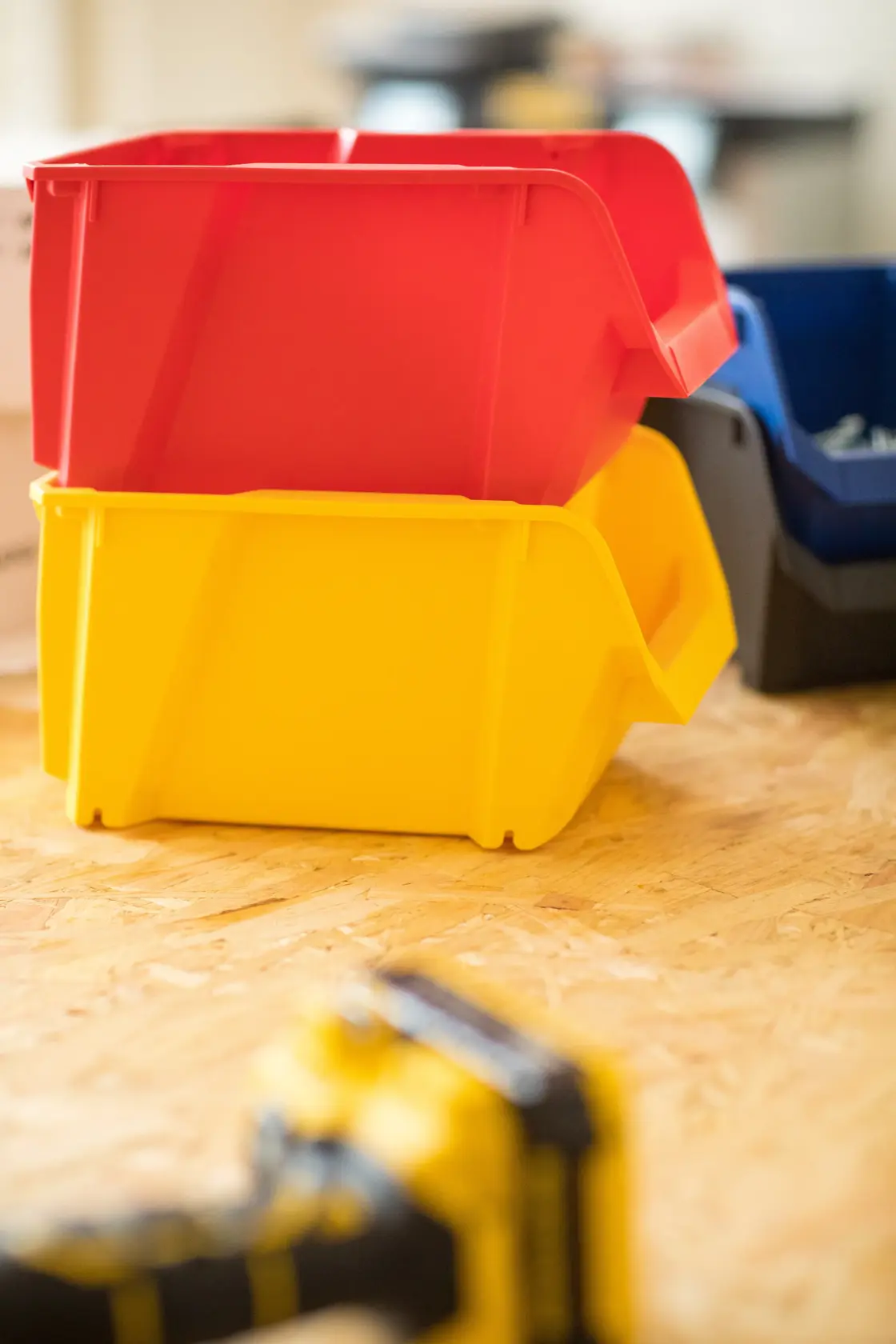 STANLEY STST82739-1 stackable red and yellow storage bins on wood surface, photography side angle.