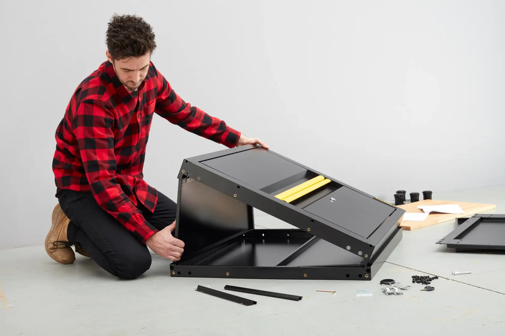 STANLEY STST97595-1 metal cabinet assembly in progress, black panels, yellow handle, accessories visible.