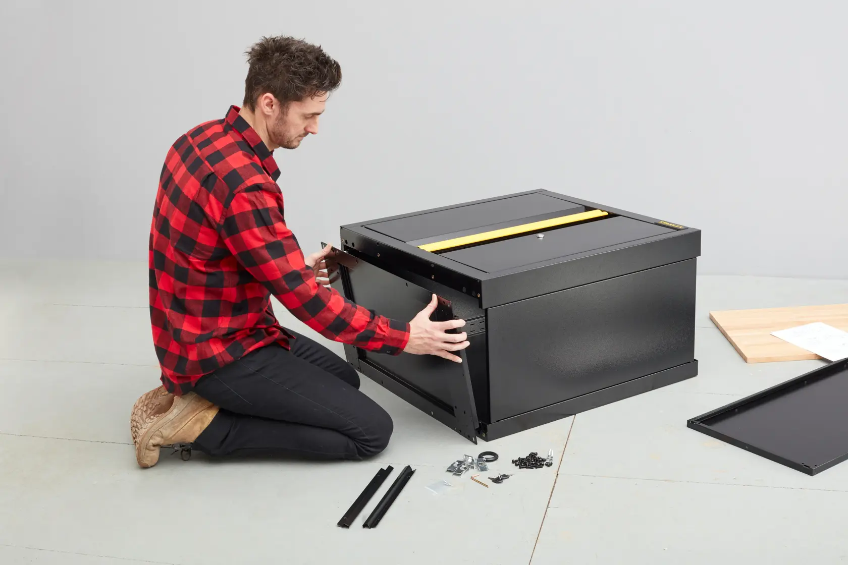 STANLEY STST97595-1 black tool chest assembly in progress with hardware and panels on floor.